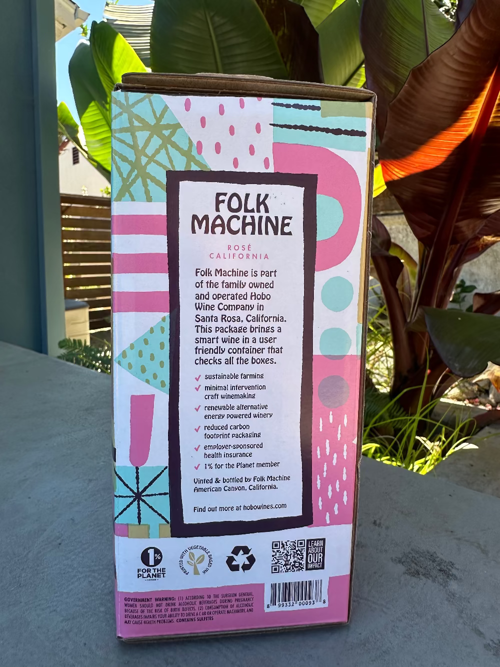 Folk Machine wine box with colorful design on a table outdoors