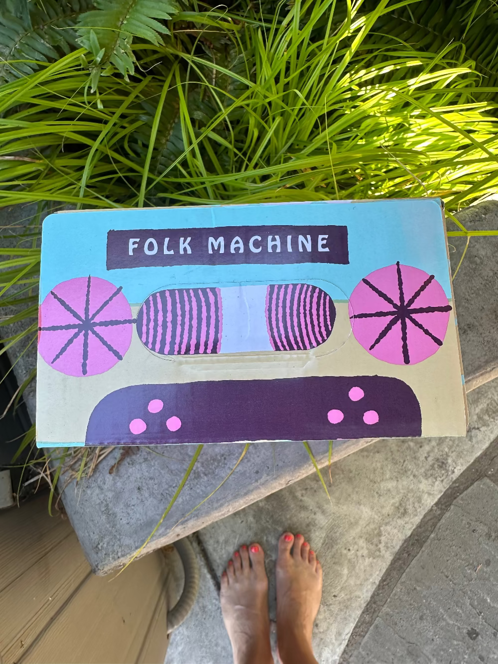 Folk Machine mat on a stone surface with grass in the background